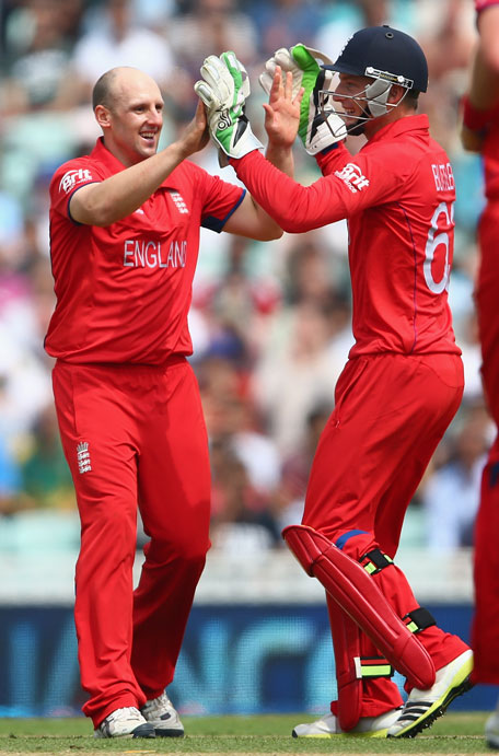 James Tredwell of England celebrates with Jos Buttler after taking the wicket of Jean-Paul Duminy of South Africa during the ICC Champions Trophy Semi-Final match at The Oval on June 19, 2013 in London, England. (GETTY)