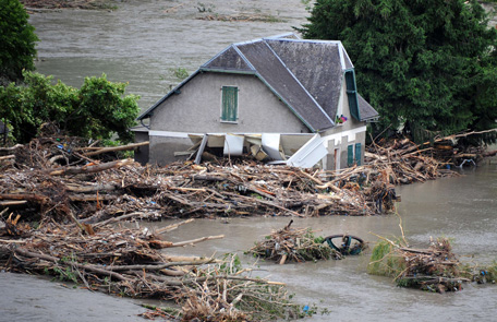 A flooded house is pictured one day after the village of Saint-Beat was submerged by flash floods on June 19, 2013.  Flash floods in southwestern France claimed two elderly victims in the space of 24 hours and forced the inundated grotto at Lourdes to remain closed for a second day, officials said. (AFP)