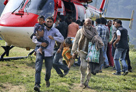 In this Friday June 21, 2013 photo, Indian pilgrims who were stuck in the upper reaches of mountains are brought to safer place, in Joshimath, in northern Indian state of Uttrakhand. Officials say soldiers are working to evacuate tens of thousands of people still stranded in northern India where nearly 600 people have been killed in monsoon flooding and landslides. (AP)