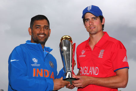 India captain MS Dhoni (left) poses with the ICC Champions Trophy alongside England skipper Alastair Cook at Edgbaston on June 22, 2013 in Birmingham, England. (GETTY)