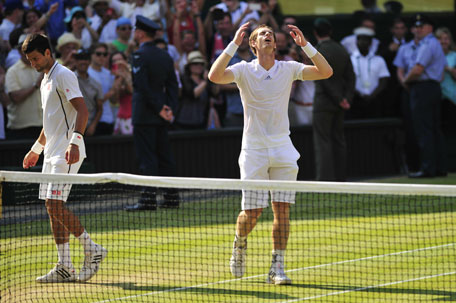 Britain's Andy Murray (right) celebrates beating Serbia's Novak Djokovic during the men's singles final on day thirteen of the 2013 Wimbledon Championships tennis tournament at the All England Club in Wimbledon, London, on July 7, 2013. (AFP)