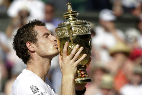 Andy Murray of Britain kisses the winner's trophy after defeating Novak Djokovic of Serbia in their men's singles final at the Wimbledon Tennis Championships, in London July 7, 2013. (REUTERS)
