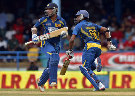 Sri Lankan cricketers Lahiru Thirimanne (right) and Kumar Sangakkara take a single during the fifth match of the Tri-series at the Queen's Park Oval in Port of Spain on July 7, 2013. (AFP)
