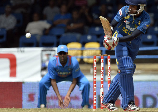 Sri Lankan opener Upul Tharanga (right) plays a shot during Tri-series final against India at the Queen's Park Oval stadium in Port of Spain on July 11, 2013. (AFP)