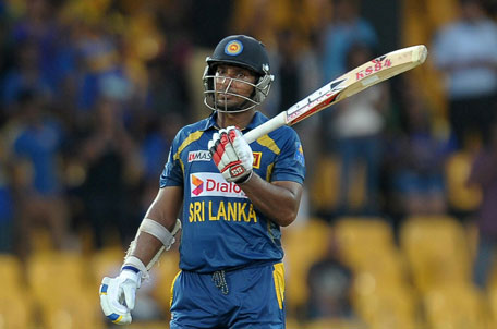 Sri Lankan batsman Kumar Sangakkara raises his bat after he scored 150 runs during the first one-day international against South Africa at the R. Premadasa Stadium in Colombo on July 20, 2013. (AFP)
