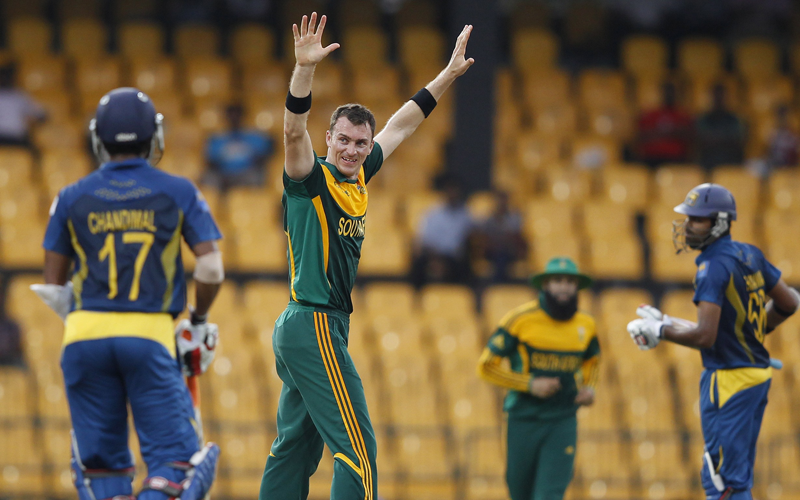 South Africa's Ryan McLaren (C) celebrates taking the wicket of Sri Lanka's Lahiru Thirimanne (R) during the second One Day International match in Colombo. (REUTERS)