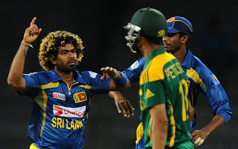 Sri Lankan cricketer Lasith Malinga (L) celebrates the wicket of South African batsman Robin Peterson (C) during second One Day International (ODI) cricket match between Sri Lanka and South Africa at the R. Premadasa Stadium in Colombo on July 23, 2013. (AFP)
