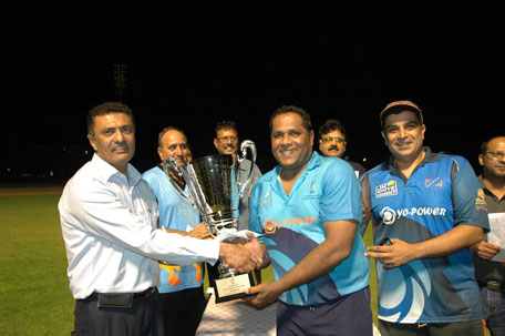 Yogi skipper Avadoot Amonkar and team owner Shiva Pagarani receive their winner's trophy and cash award from DCC honorary Secretary Mohamed Lokhandwala. (SUPPLIED)