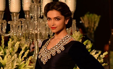 Indian Bollywood actress Deepika Padukone presents a creation by Indian fashion designer Manish Malhotra during the Grand Finale of PCJ Delhi Couture Week 2013 in New Delhi on August 4, 2013. (AFP)