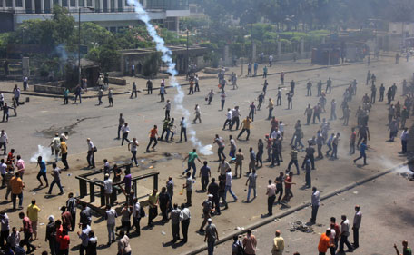 Supporters of Egypt's ousted President Mohammed Morsi clash with security forces near the largest sit-in by supporters of Morsi in the eastern Nasr City district of Cairo, Egypt, Wednesday, Aug. 14, 2013. Egyptian police in riot gear swept in with armored vehicles and bulldozers Wednesday to clear the sit-in camps set up by supporters of the country's ousted Islamist president in Cairo, showering protesters with tear gas as the sound of gunfire rang out.  (AP)
