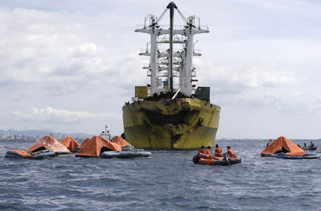 A cluster of life rafts floate near the cargo ship Sulpicio Express Siete with its damaged bow a day after it collided with a passenger ferry off the waters of Talisay city, Cebu province in central Philippines, Saturday Aug. 17, 2013. Divers combed through a sunken ferry Saturday to retrieve the bodies of more than 200 people still missing from an overnight collision with a cargo vessel near the central Philippine port of Cebu that sent passengers jumping into the ocean and leaving many others trapped. At least 28 were confirmed dead and hundreds rescued. The captain of the ferry MV Thomas Aquinas, which was approaching the port late Friday, ordered the ship abandoned when it began listing and then sank just minutes after collision with the MV Sulpicio Express, coast guard deputy chief Rear Adm. Luis Tuason said. (AP)