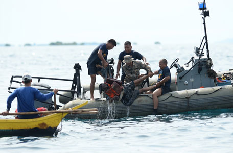 Philippine Navy personnel lift a victim from the sea during rescue operations on August 17, 2013 after a cargo ship collided with the ferry St. Thomas Aquinas the night before off the town of Talisay near the Philippines' second largest city of Cebu. Philippine rescuers searched on August 17 for more than 200 people missing after the ferry collided with the cargo ship in thick darkness and sank almost instantly, with 26 already confirmed dead. (AFP)