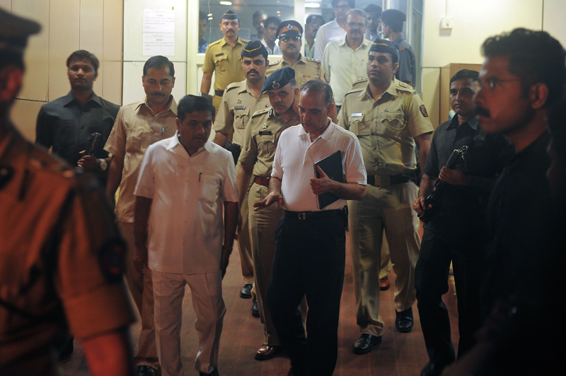 India's Maharashtra state Home Minister R.R. Patil (centre L) speaks with city Police Commissioner Satyapal Singh (centre R) as they depart the city hospital where a gang rape victim is admitted, in Mumbai early morning on August 23, 2013. Five men gang-raped a woman photographer in India's financial hub Mumbai, police said August 23, stirring memories of a similar incident eight months ago in New Delhi which triggered nationwide protests.  (AFP)
