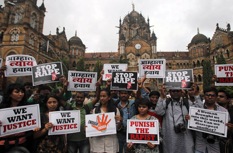 Photojournalists hold placards as they protest against the gang rape of a 22-year-old woman photojournalist in Mumbai India, Friday, Aug 23, 2013. The woman was gang raped while her male colleague was tied up and beaten in an isolated, overgrown corner of India's business hub of Mumbai, police said Friday. (AP)