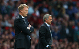 Manchester United Manager David Moyes and Chelsea Manager Jose Mourinho ((R) look on during the Barclays Premier League match between Manchester United and Chelsea at Old Trafford on August 26, 2013 in Manchester, England.  (Photo by Alex Livesey/Getty Images)