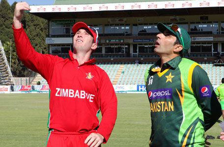Zimbabwean cricket captain Brendan Taylor, left, tosses a coin next to his Pakistani counterpart Misbah-ul-Haq on the first day of their one day international series in Harare, Tuesday, Aug. 27, 2013. Pakistan is in Zimbabwe for a month-long tour which will see them playing ODIs and Test matches against the hosts. (AP)