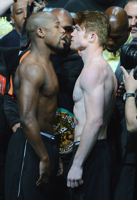 Boxers Floyd Mayweather Jr. (left) and Canelo Alvarez face off during the official weigh-in for their bout at the MGM Grand Garden Arena on September 13, 2013 in Las Vegas, Nevada. (GETTY)