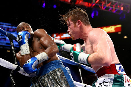 Canelo Alvarez throws a right at Floyd Mayweather Jr. during their WBC/WBA 154-pound title fight at the MGM Grand Garden Arena on September 14, 2013 in Las Vegas, Nevada. (GETTY)
