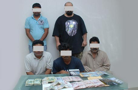 Members of the gang and smuggled money (SUPPLIED)