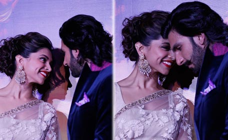 Bollywood actors Deepika Padukone and Ranveer Singh share a moment during the trailer launch of 'Ram Leela' in Mumbai, September 2013. (AFP)