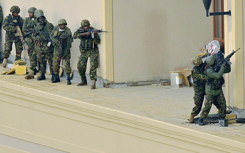 Kenyan soldiers move in formation, clearing the top floor balcony and interior of Westgate Mall on September 24in Nairobi. Kenyan Defence troops remain inside the Westgate mall, in a standoff with Somali militants after they laid siege to the shopping centre shooting and throwing grenades as they entered. (AFP)