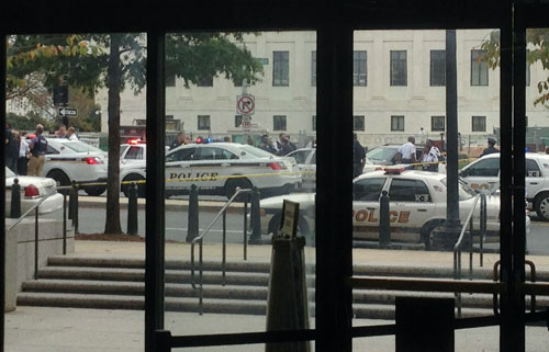 Law enforcement vehicles converge on the scene of a shooting on Constitution Avenue outside the Hart U.S. Senate Office Building as seen from inside the lobby of the building on Capitol Hill in Washington, October 3, 2013. (REUTERS)