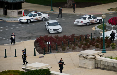 Seen from the inside of the US Capitol, Capitol Police respond to reports of a shooting outside of the Senate side of the US Capitol on October 3, 2013 in Washington, DC. (AFP)