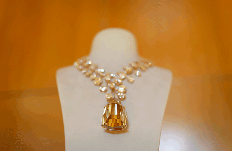 A rose gold necklace with a 407 carat yellow diamond is presented on a stand during a media event in Singapore October 4, 2013. For someone with $55 million to spare on an egg-sized diamond, the world's most expensive necklace is on sale this month at a jewellery show in Singapore, reflecting Asia's growing appetite for precious gems and expensive baubles.   (REUTERS)