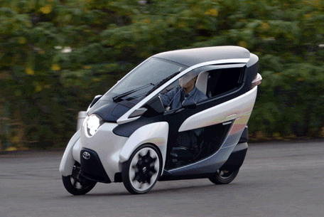 This photo taken on October 10, 2013 shows a journalist driving Japanese auto giant Toyota Motor's prototype model electric trike "i-Road", in Tokyo. Cars that drive themselves -- and avoid collisions -- could be on the market within a few years as the world's biggest vehicle maker showed off its latest automated driving technology. (AFP)