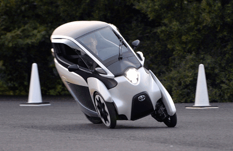 This photo taken on October 10, 2013 shows a journalist driving Japanese auto giant Toyota Motor's prototype model electric trike "i-Road", in Tokyo. Cars that drive themselves -- and avoid collisions -- could be on the market within a few years as the world's biggest vehicle maker showed off its latest automated driving technology.  (AFP)