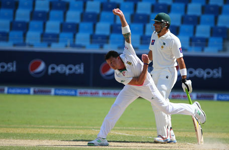 Dale Steyn of South Africa delivers a ball as Pakistan's captain Misbah Ul-Haq looks on during the first day of the second Test in Dubai on October 23, 2013. (AFP)