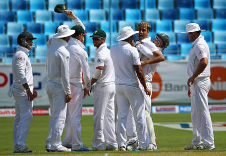 South African cricketers celebrate after Imran Tahir (right) took a wicket against Pakistan during the first day of the second Test in Dubai on October 23, 2013. (AFP)