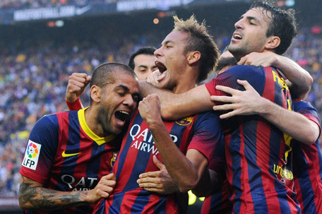 Neymar (centre) of FC Barcelona celebrates with his team-mates Dani Alves (left) and Cesc Fabregas after scoring the opening goal during the La Liga match against Real Madrid CF at Camp Nou on October 26, 2013 in Barcelona, Spain. (GETTY)