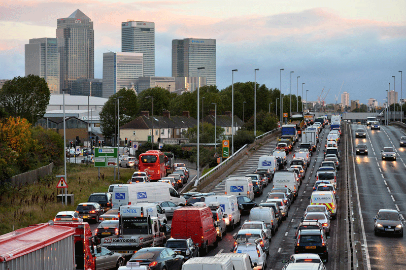 Traffic queues on a main route into London by the towers of London's financial district Canary Wharf on October 28 after a strong storm causes travel disruption. Britain faced travel chaos on October 28 and over 200,000 homes were without power as one of the worst storms in years battered southern England, sweeping at least one person out to sea. (AFP)