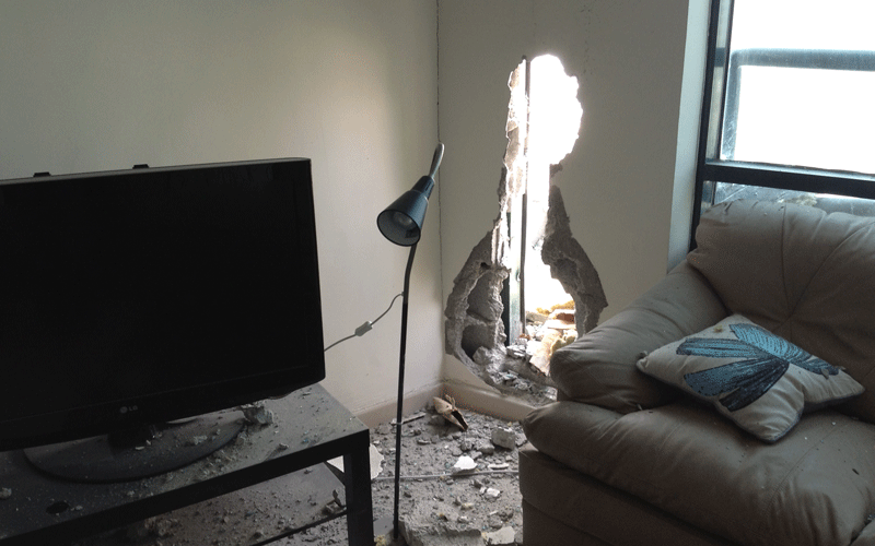 The accident created a whole in the wall of the living room.
