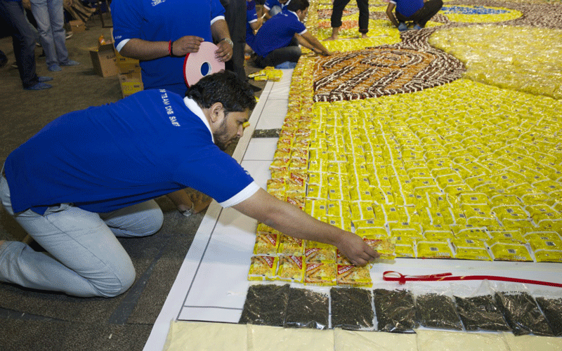 Sharp MEA employees putting together the world's largest packaged food mosaic.