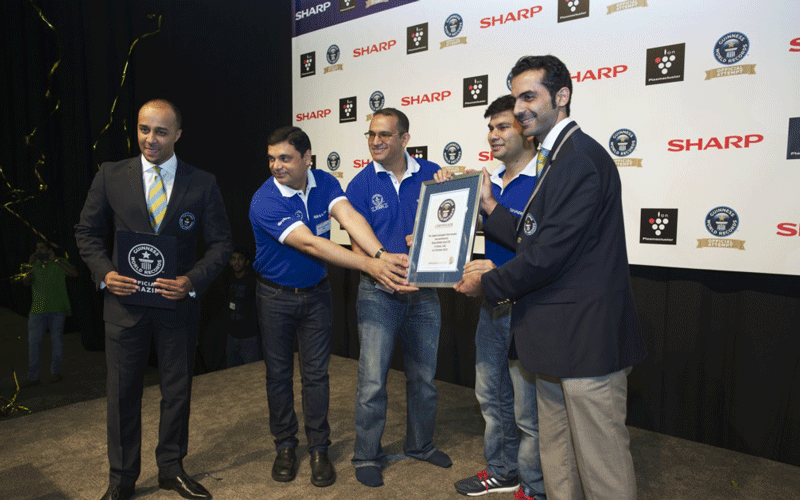 Sharp MEA officials receiving the Guinness World Records certificate for the largest packaged food mosaic.