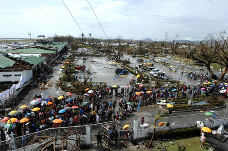 Typhoon survivors queue up to receive relief goods being distributed at the Tacloban airport in Tacloban, on the eastern island of Leyte on November 10, 2013 after Super Typhoon Haiyan swept over the Philippines. (AFP)