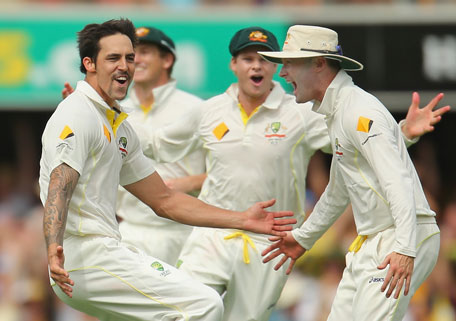 Mitchell Johnson of Australia celebrates with Michael Clarke after dismissing Joe Root of England during day two of the First Ashes Test at The Gabba on November 22, 2013 in Brisbane, Australia. (GETTY)