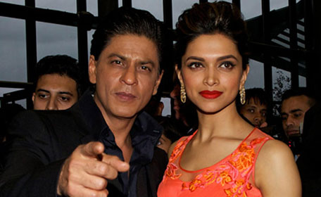Shah Rukh Khan and Deepika Padukone pose for pictures on the red carpet at a promotional event for the Hindi film Chennai Express in Feltham, west London. (AFP)