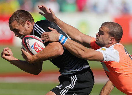 Joe Webber of New Zealand is tackled by Ramiro Moyano of Argentina during the Emirates Dubai Sevens Cup quarter-final at The Sevens stadium on November 30, 2013 in UAE. (GETTY)