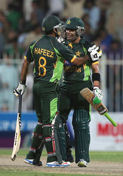 Mohammad Hafeez (left) and Umar Akmal during the Twenty20 match between Afghanistan and Pakistan at the Sharjah Cricket Stadium on December 8, 2013 in Sharjah, UAE. (GETTY)