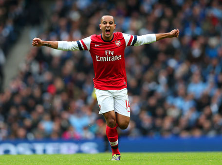 Theo Walcott of Arsenal celebrates scoring their first goal during the Barclays Premier League match between Manchester City and Arsenal at Etihad Stadium on December 14, 2013 in Manchester, England. (GETTY)