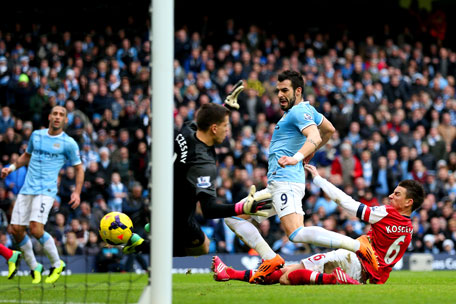 Laurent Koscielny of Arsenal fails to stop Alvaro Negredo of Manchester City scoring their second goal during the Barclays Premier League match between Manchester City and Arsenal at Etihad Stadium on December 14, 2013 in Manchester, England. (GETTY)