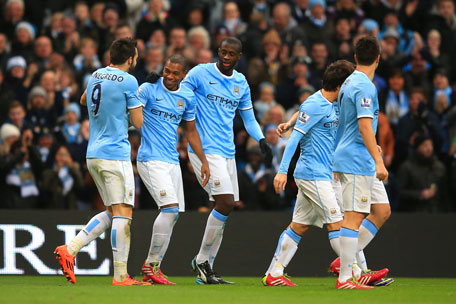 Fernandinho of Manchester City celebrates with team mates after scoring their third goal during the Barclays Premier League match between Manchester City and Arsenal at Etihad Stadium on December 14, 2013 in Manchester, England. (GETTY)