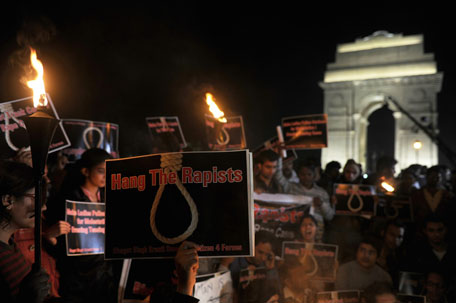 FILE: Indian students and activists carry placards at India Gate during a protest following the gang-rape of a student in the Indian capital.   India erupted in protest following the fatal gang-rape of a 23-year-old physiotherapy student on December 16, 2012. (AFP)