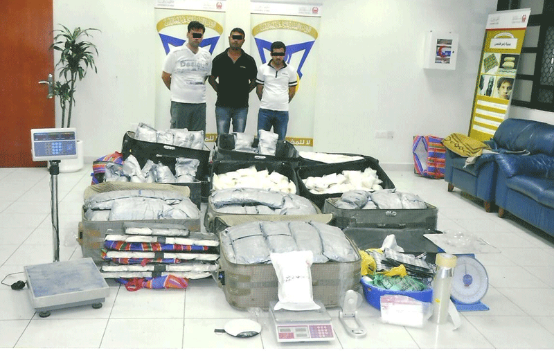 The three men caught by UAE police with some of the narcotic substances found in their possession.
