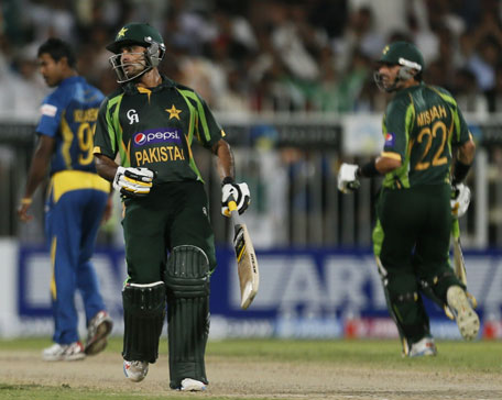 Pakistani batsmen Mohammad Hafeez (left) and Misbah-ul-Haq play a shot during the third one-day international between Pakistan and Sri Lanka at the Sharjah Cricket Stadium in UAE on December 22, 2013. (AFP)