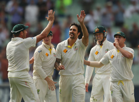 Ryan Harris (left) and David Warner (right) congratulate Mitchell Johnson of Australia after he dismissed Jonny Bairstow of England during day one of the 4th Ashes Test between Australia and England at Melbourne Cricket Ground on December 26, 2013 in Melbourne, Australia. (GETTY)