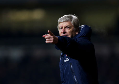 Arsenal manager Arsene Wenger signals during the Barclays Premier League match between West Ham United and Arsenal at Boleyn Ground on December 26, 2013 in London, England. (GETTY)